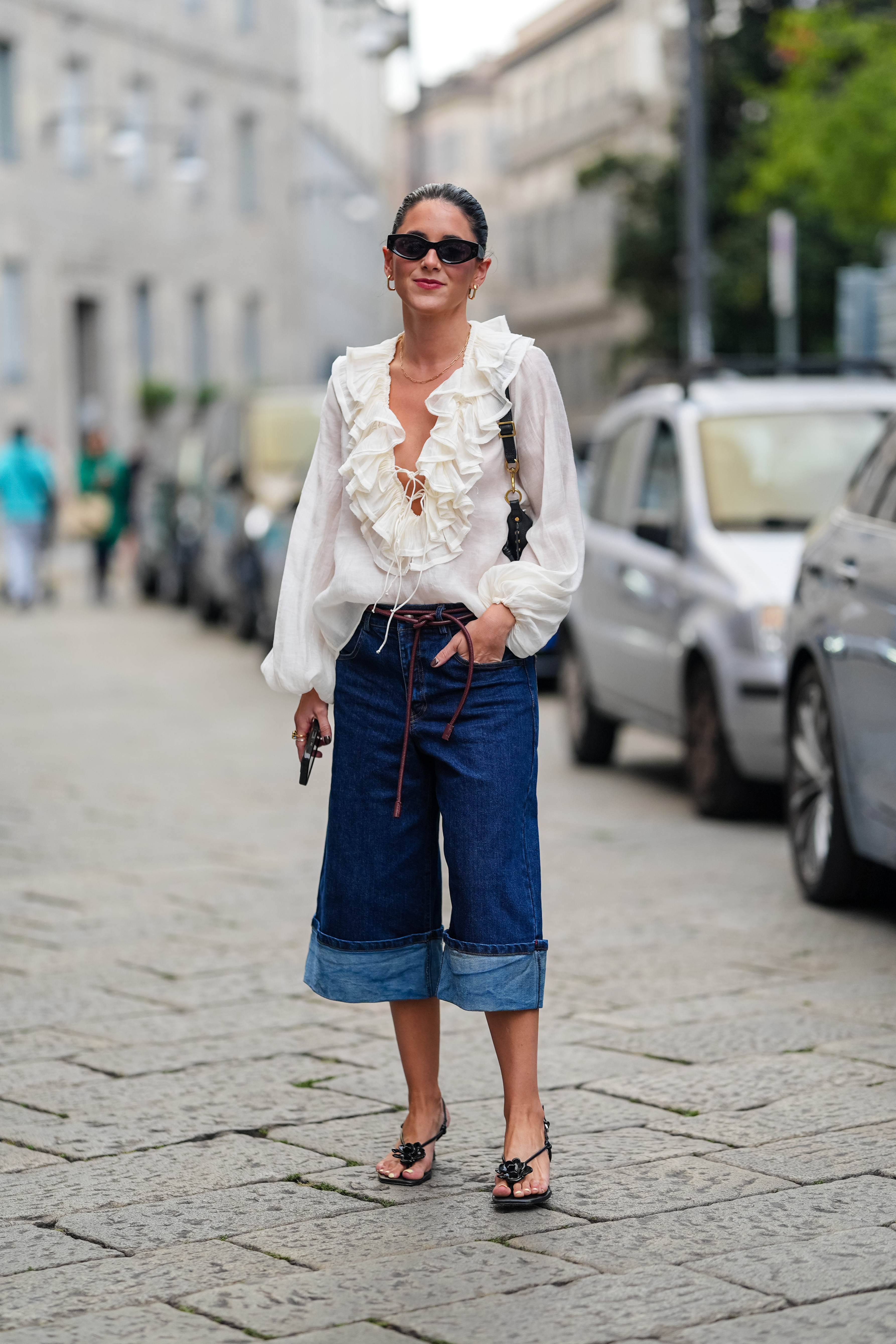 woman wearing denim culottes and a white shirt