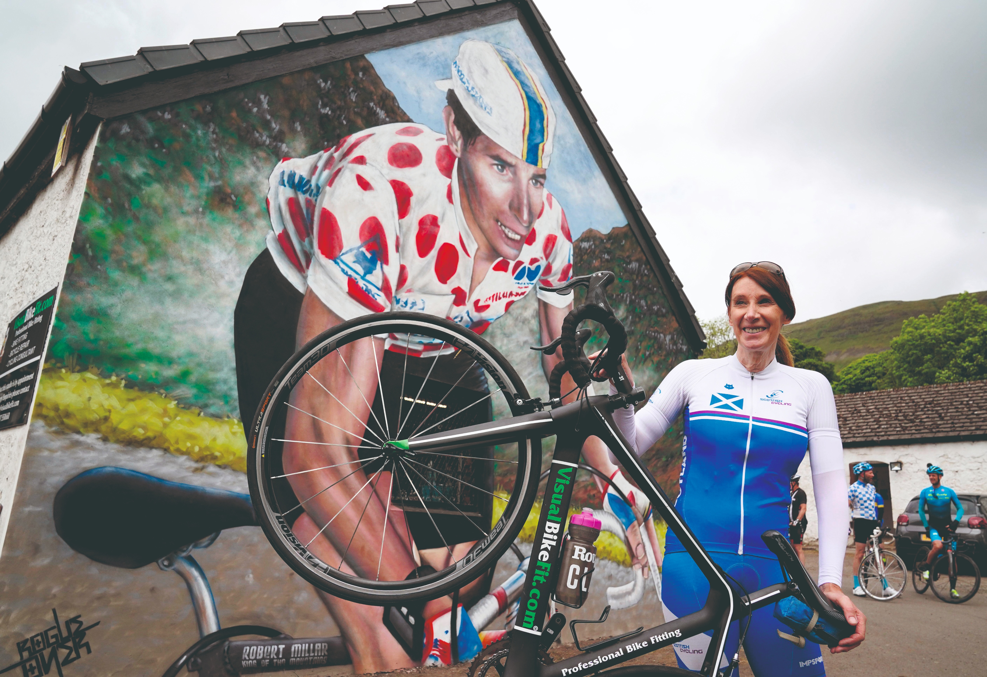 Pippa York with a mural of Robert Millar