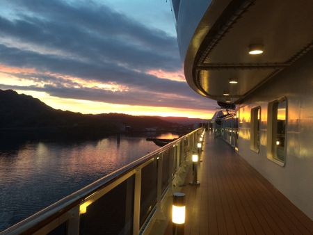 Cruise ship at sunset near the shores of a tropical island.