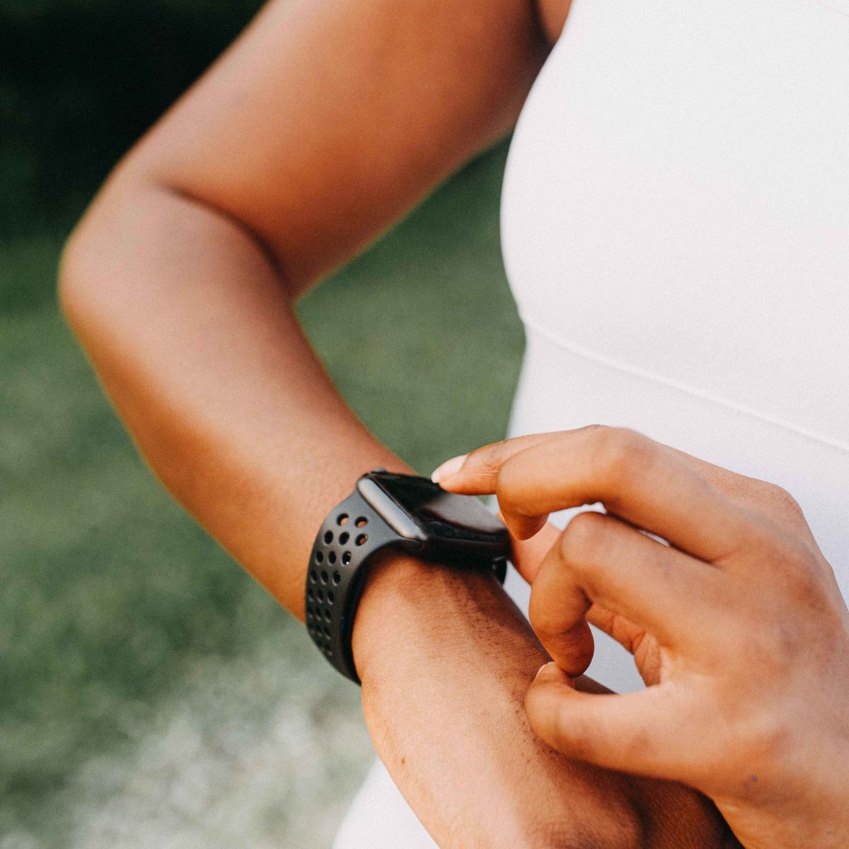 close up of woman wearing a black smart watch