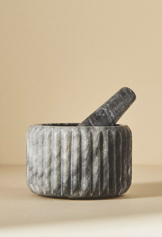 grey marble mortar and pestle sitting on a flat surface