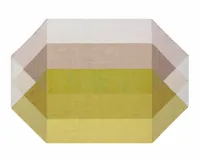 A diamond-shpaed outdoor rug in yellow, pink and white colourways