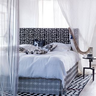 black patterned bed with gauze curtain