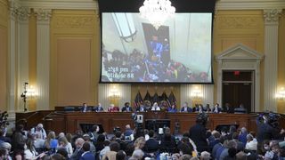 A video of Jan. 6 rioters inside the US Capitol is displayed on a screen during a hearing of the Select Committee to Investigate the January 6th Attack on the US Capitol in Washington, D.C., US, on Thursday, July 21, 2022.