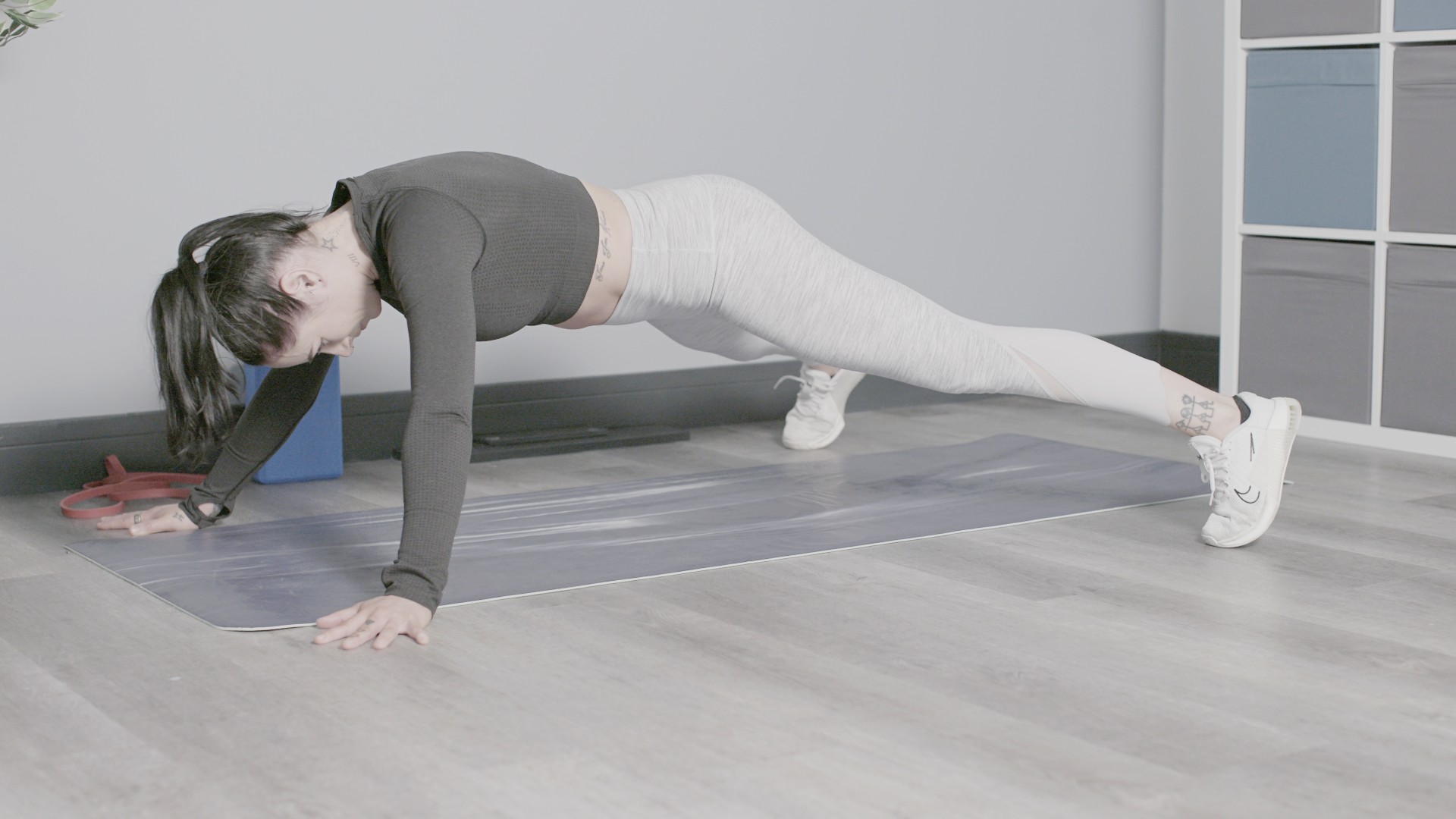 X plank demonstrated by writer Sam in studio