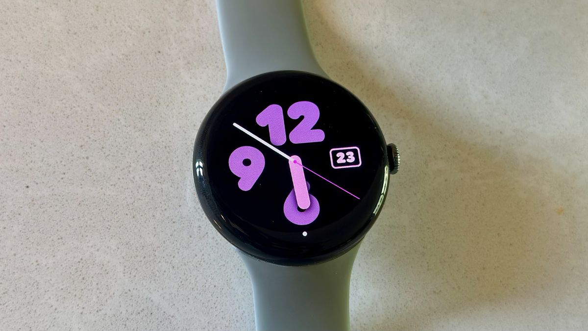 The Google Pixel Watch 3 on a white counter, showing the Analog Bold watch face.