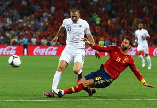 Spain's Sergio Ramos slides in to challenge France's Karim Benzema at Euro 2012.