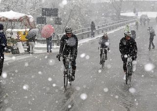 Racers in the snow at Milan-San Remo