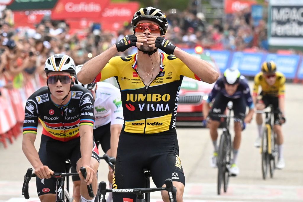 Roglič celebrates his stage win ahead of Evenepoel