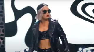 Toni Storm in her black sunglasses and backward cap in AEW