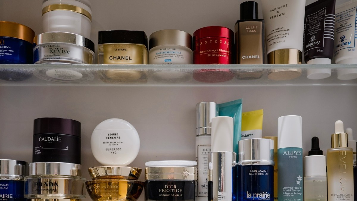 Photo of many skincare products on a bathroom shelf 