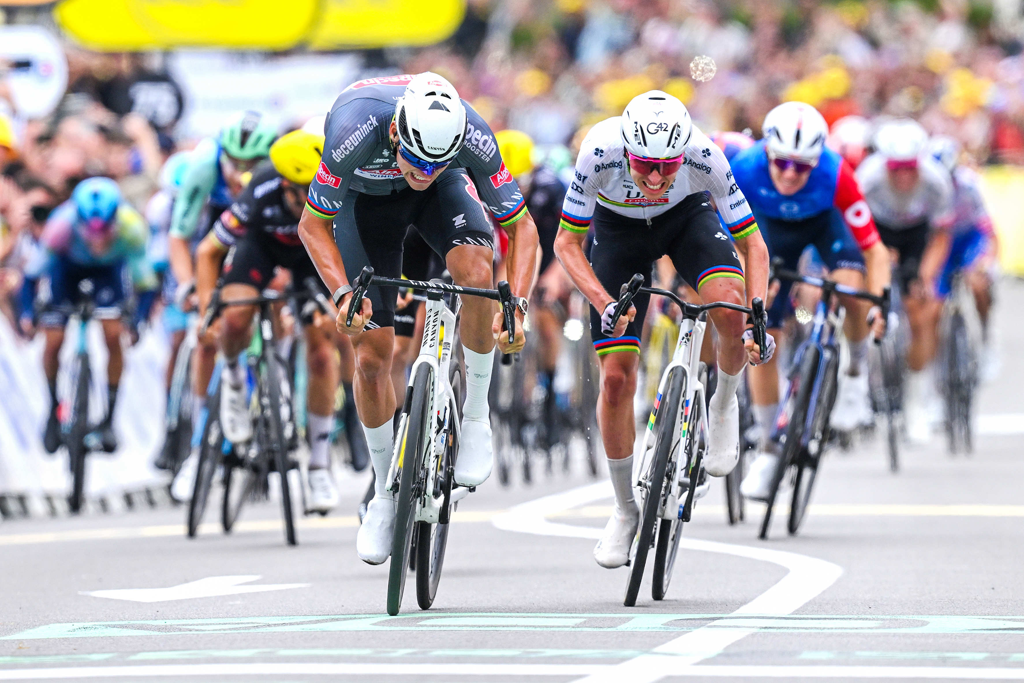 Tadej Pogacar and Mathieu van der Poel sprint for the line on stage 2 of the 2025 Tour de France