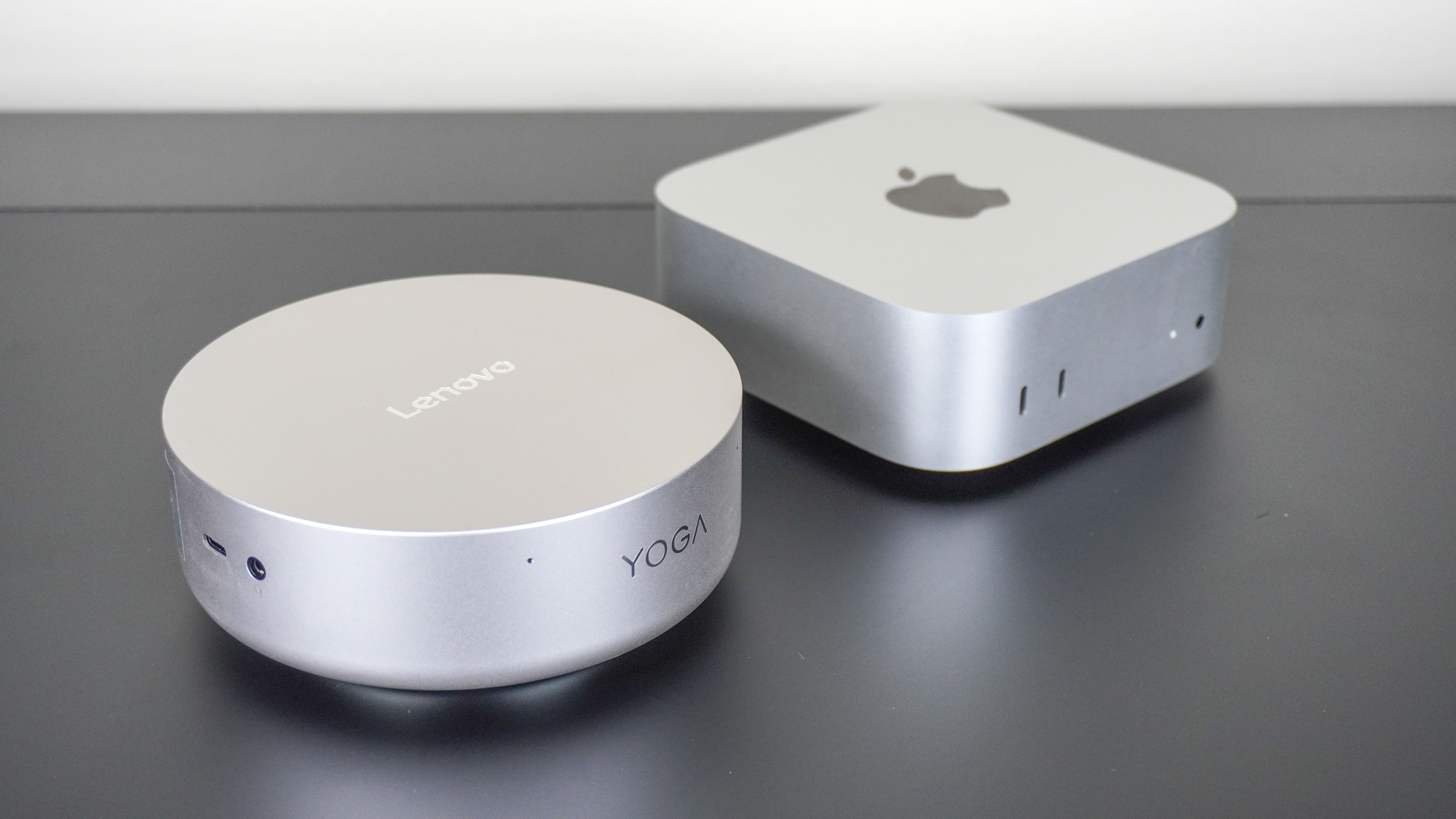 The Lenovo Yoga Mini next to the Apple Mac mini M4 on a desk