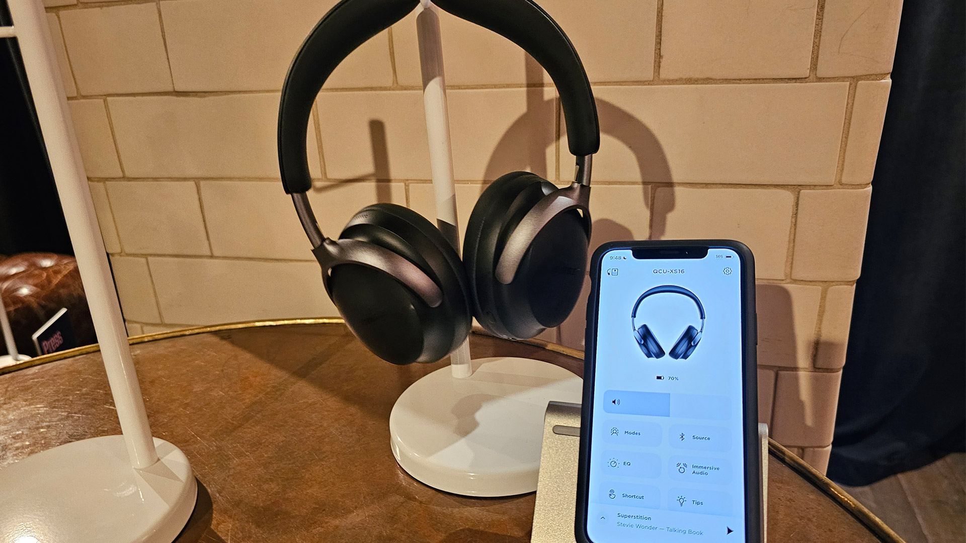 Bose QuietComfort Ultra headphones next to phone