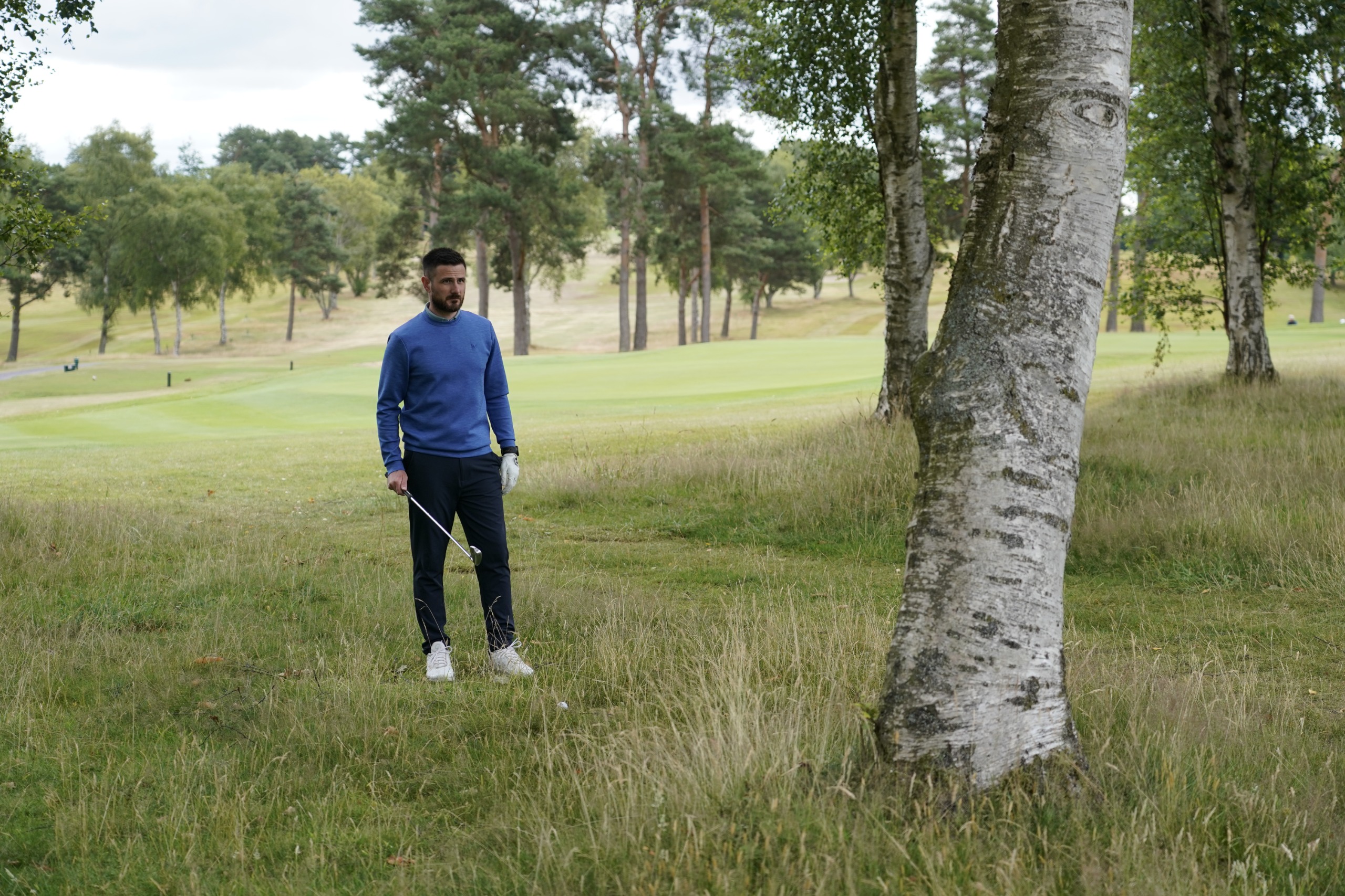 Baz Plummer assessing his options before hitting a shot from the rough behind a tree
