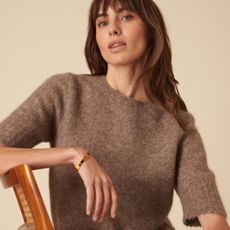 Woman wears short sleeved knit top