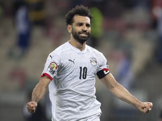 Mohamed Salah celebrates after scoring the winning penalty for Egypt against Ivory Coast at the 2021 Africa Cup of Nations in January 2022.