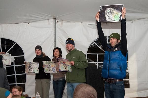 Travis McMaster holds up his winning creation for the Kona Bikes 24 Hours in the Old Pueblo coloring contest on the eve of the race. Each year, event sponsor Cirrus Visuals of Tucson, Arizona holds a coloring contest at the dedication dinner with an impromptu panel of judges awarding a prize to their preferred artist.