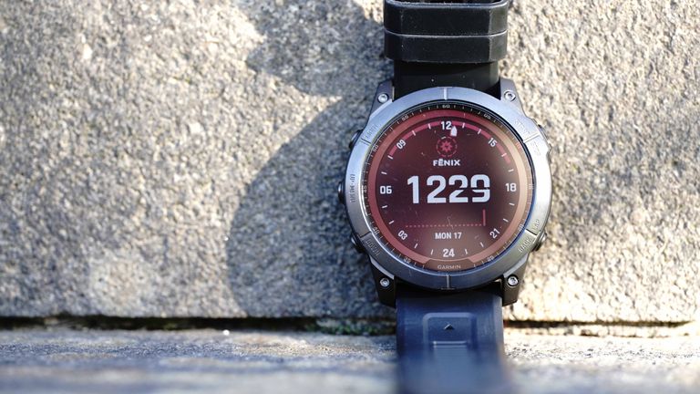 Garmin Fenix 7x review: Pictured here, the Fenix 7X placed on a wall against a concrete wall