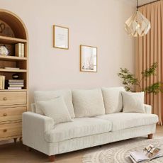 A modern lounge with a cream, corduroy sofa from Wayfair.