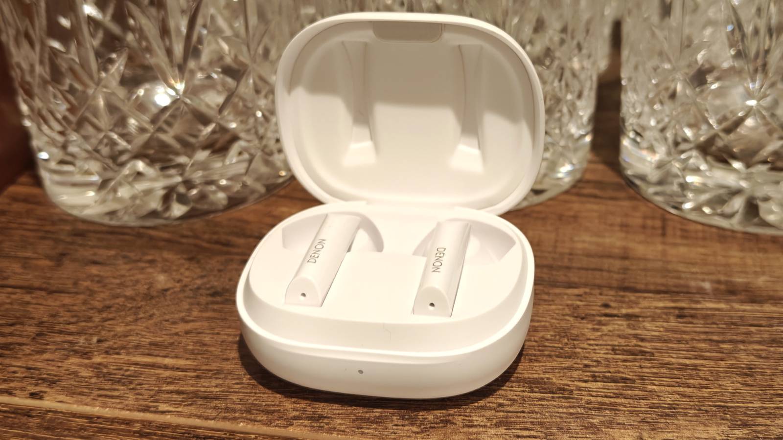 The Denon AH-C500W buds in the case, which is open.