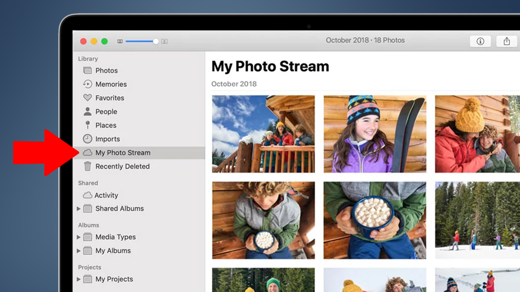 A MacBook on a blue background showing the My Photo Stream menu in Apple Photos