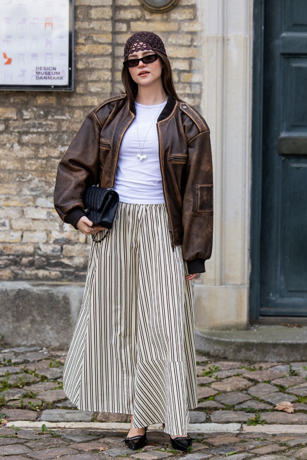 Stripe Trend Copenhagen Fashion Week SS26 Street Styler wearing bomber jacket, T-shirt and stripe skirt