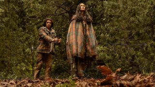 Lottie standing on The Pit while Travis stares in shock in Yellowjackets Episode 309