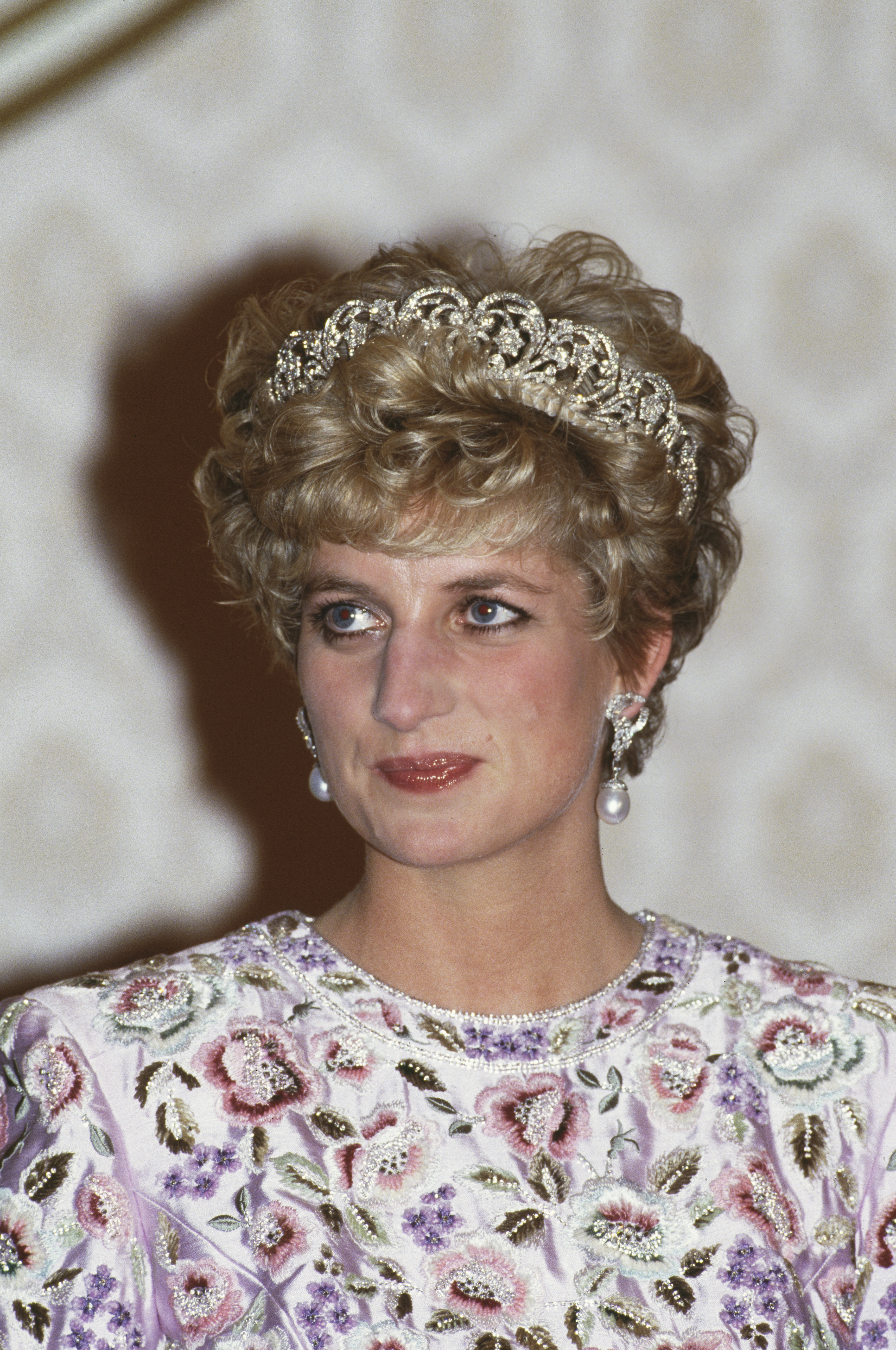 Princess Diana wearing a white floral dress and the Spencer tiara