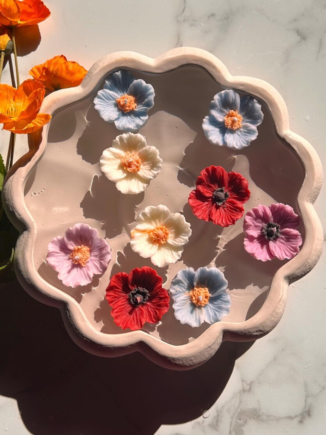 A set of poppy shaped floating candles