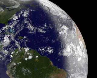 When the GOES-13 satellite passed over Katia (right, center) on Aug. 30, 2011, just after daylight reached it in the Atlantic, it revealed a well-developed storm. The bright vertical line on the Earth shows daylight to the east of the line, and imagery is visible.