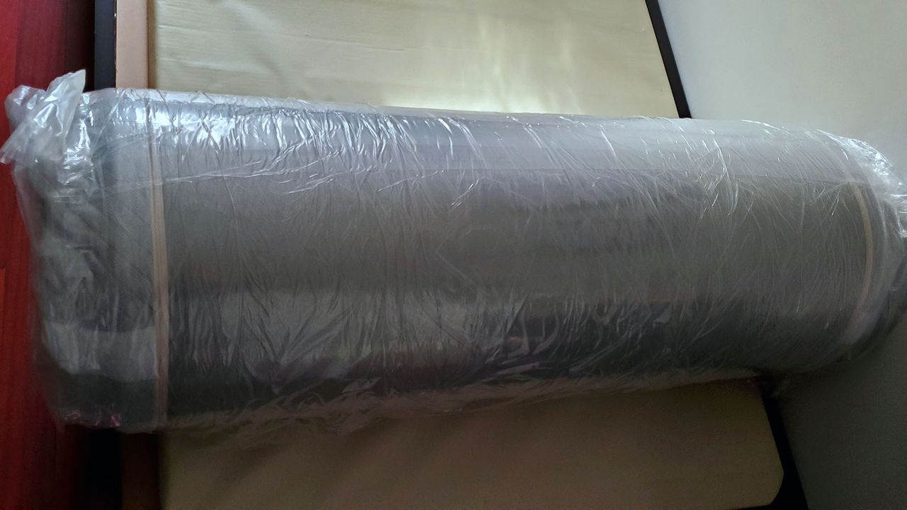 Leesa Original Mattress rolled up in plastic