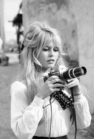 Brigitte Bardot taking photos with a vintage camera
