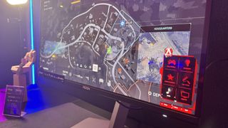 AOC gaming monitor in a darkly lit room, with an OSD on the bottom right