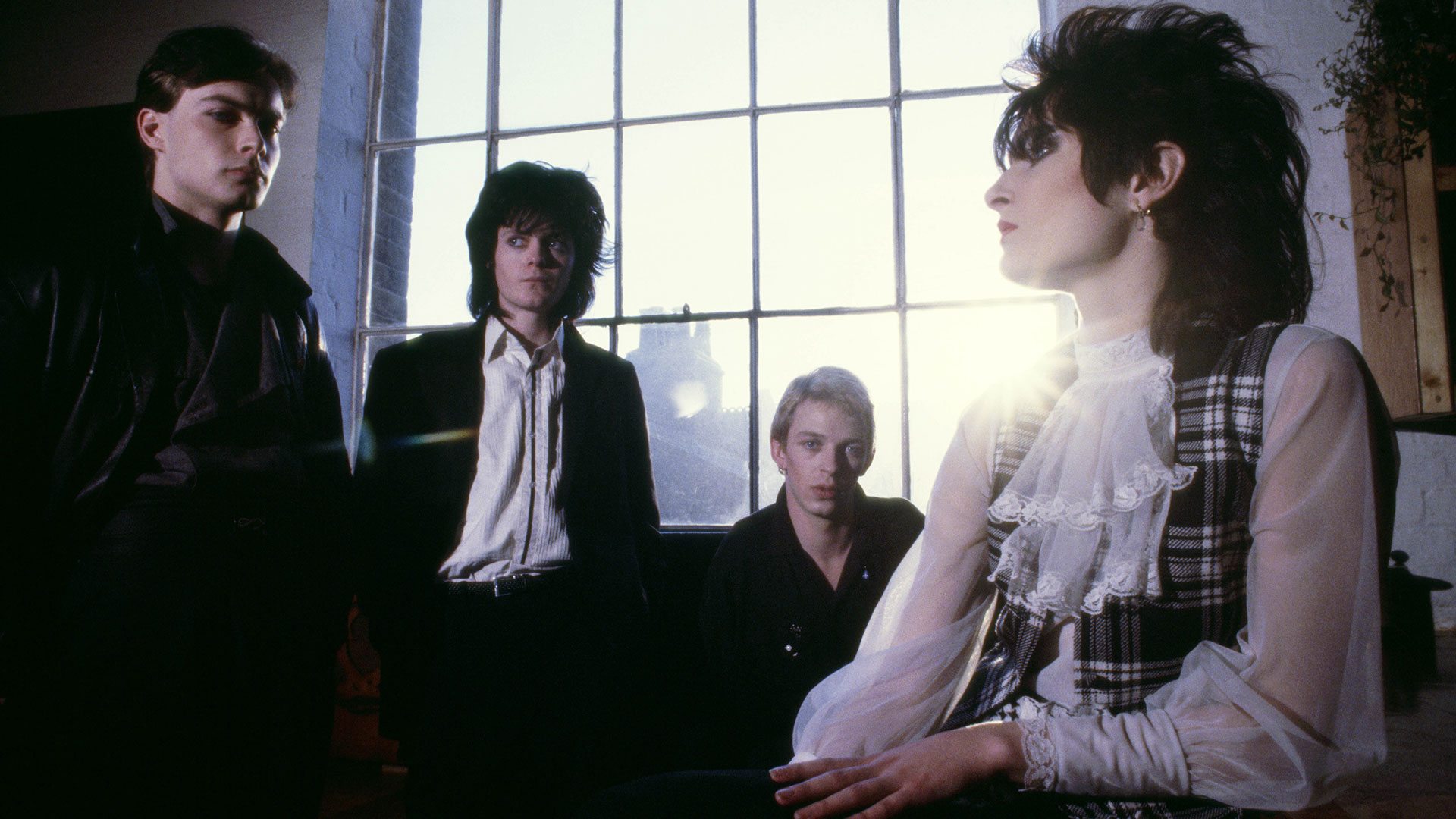 A 1979 image of Siouxsie and the Banshees in front of a window (L-R John McKay, Kenny Morris, Steve Severin and Siouxsie Sioux)
