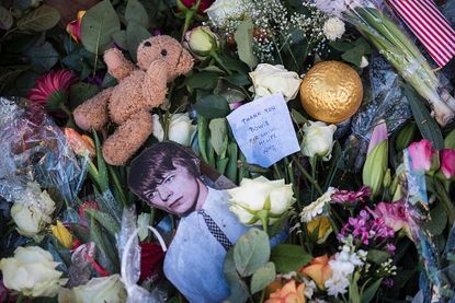 Tributes to the late David Bowie at a memorial outside his former home in Berlin.