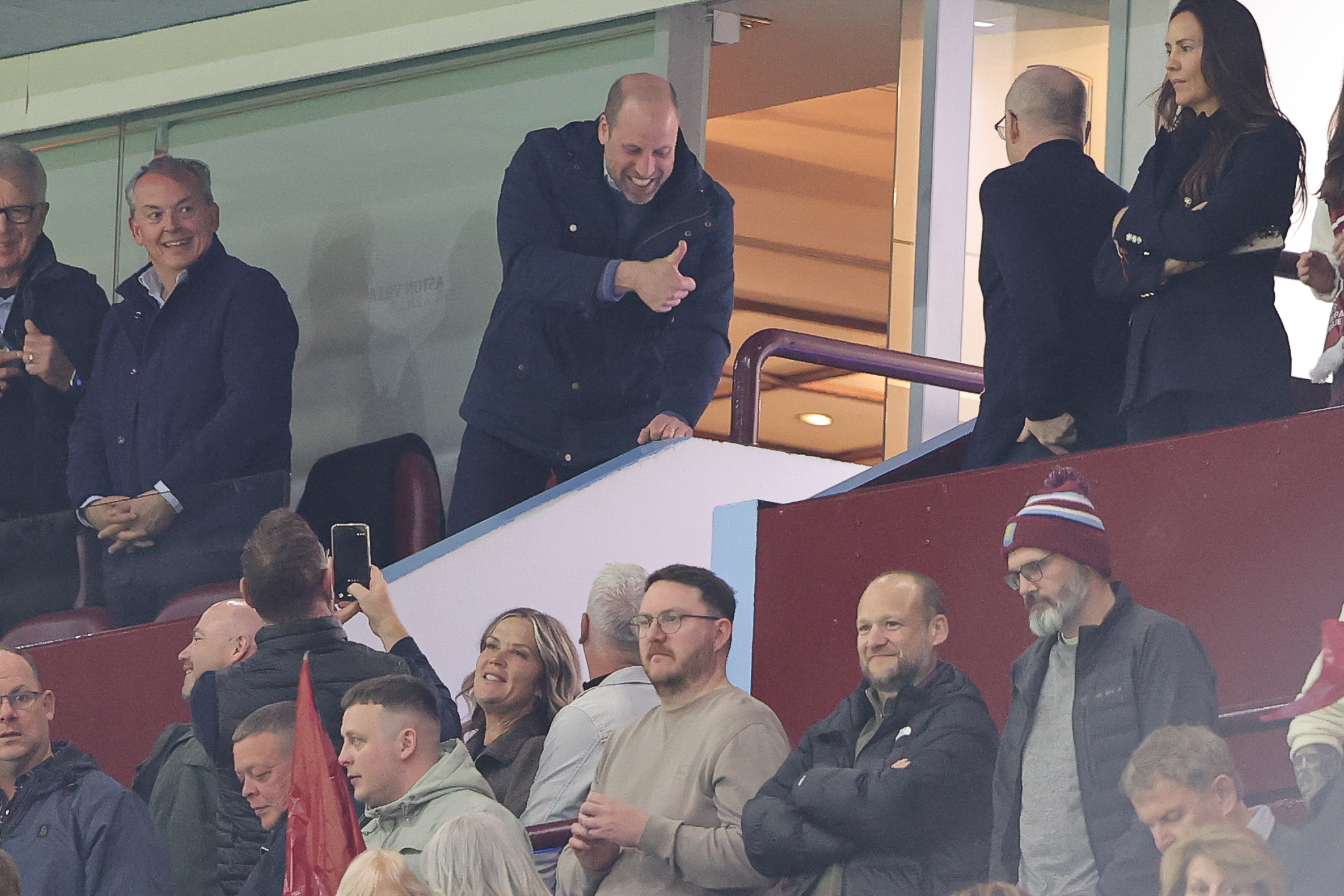Prince William giving fans a thumbs up at a soccer match