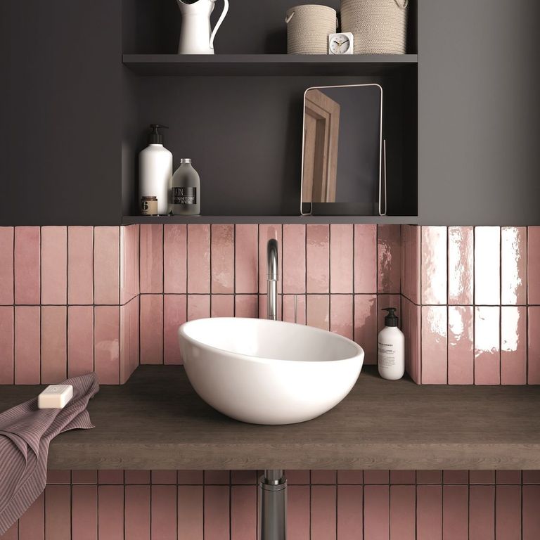Pink tiles in a dark painted bathroom