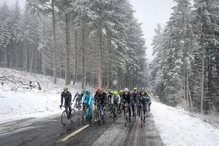 The peloton makes its way through the snow during stage 3 at Paris-Nice.