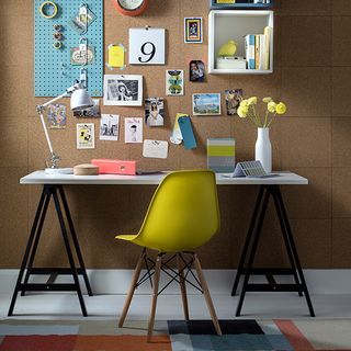 room with brown wall yellow chair and white desk