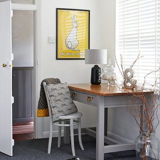 Home office with desk and lamp in garage conversion