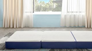 Gel Mmeory Foam trifold mattress on the floor by an open window