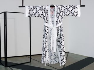 Black and white robe hanging on a black rail