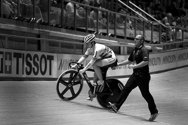 Anna Meares from Australia is led to the startline by her coach Gary West for her ride in the women's sprint final.