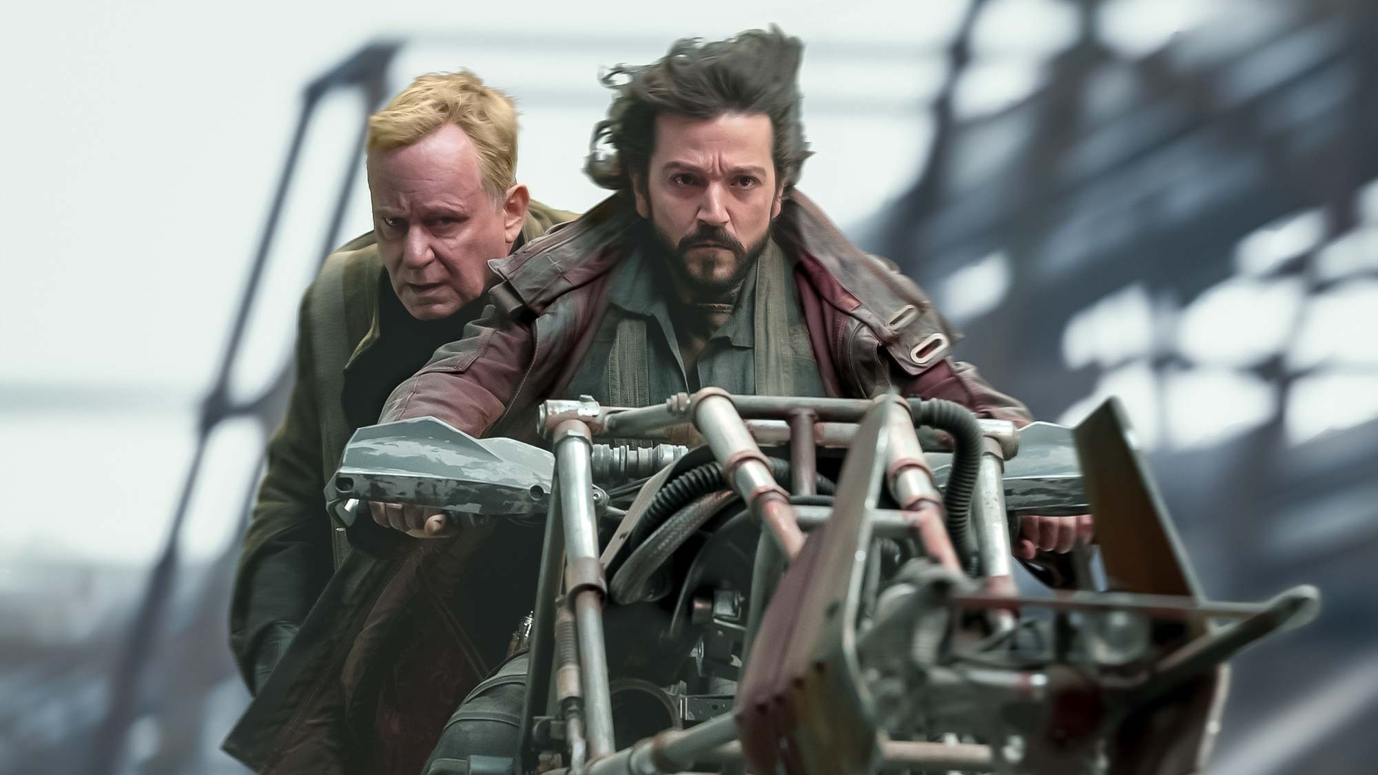 (L-R): Stellan Skarsgard (as Luthen Rael) and Diego Luna (Cassian Andor) on a speeder bike in ANDOR