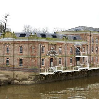 house exterior with brick wall and lake view