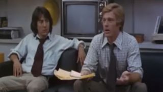 Dustin Hoffman and Robert Redford sitting on a couch in All The President's Men