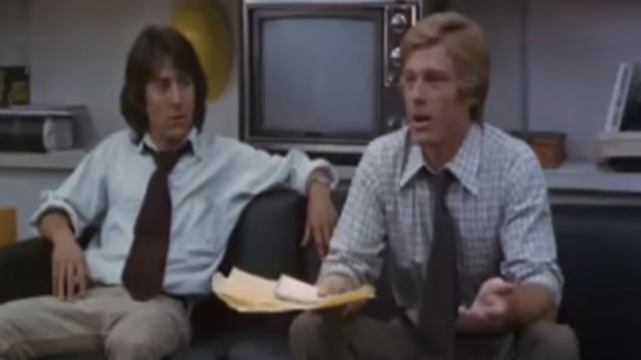 Dustin Hoffman and Robert Redford sitting on a couch in All The President's Men