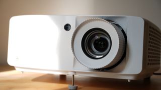 Optoma UHZ66 projector on table