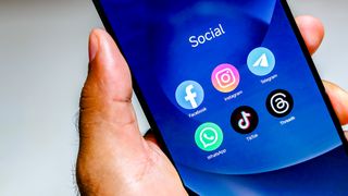 Facebook, Instagram, WhatsApp, TikTok and Threads apps logo is displayed on a smartphone screen